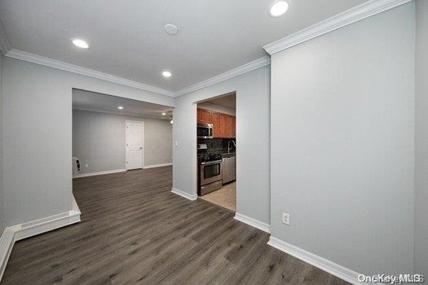 Empty room, Interior, Kitchen, Recessed Lighting, Stainless Steel Appliances, Wood Texture Flooring