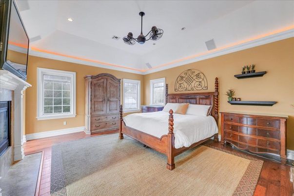 Bedroom, Chandelier, Fireplace, Interior, Recessed Lighting, Wood Texture Flooring