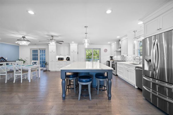 Chandelier, Dining room, Interior, Kitchen, Pendant Lights, Recessed Lighting, Stainless Steel Appliances, Wood Texture Flooring