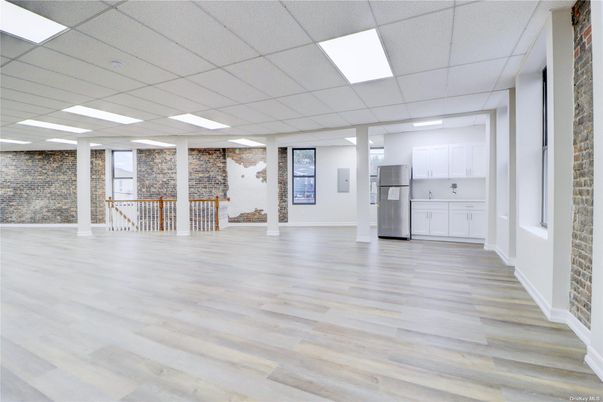 Empty room, Interior, Kitchen, Recessed Lighting, Stainless Steel Appliances, Stone Walls, Wood Texture Flooring