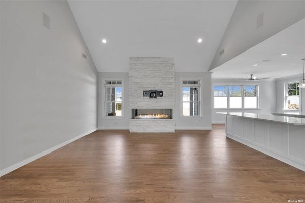 Empty room, Fireplace, Interior, Pendant Lights, Recessed Lighting, Stone Walls, Wood Texture Flooring