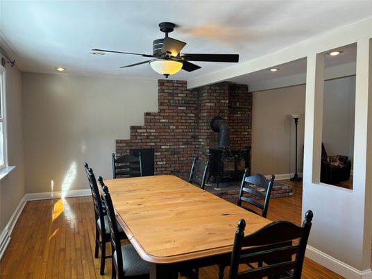 Dining room, Fireplace, Interior, Recessed Lighting, Stone Walls, Wood Texture Flooring