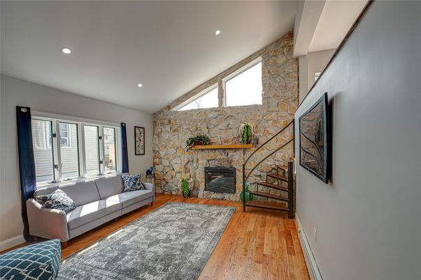 Fireplace, Interior, Living room, Recessed Lighting, Stone Walls, Wood Texture Flooring