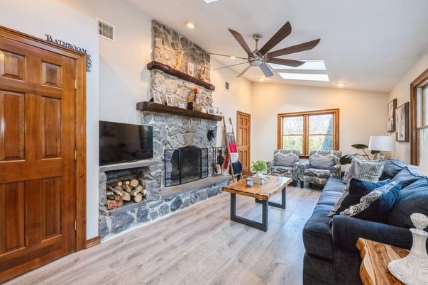 Fireplace, Interior, Living room, Recessed Lighting, Stone Walls, Wood Texture Flooring