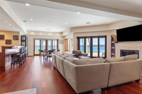Dining room, Fireplace, Interior, Living room, Recessed Lighting, Water, Wood Texture Flooring
