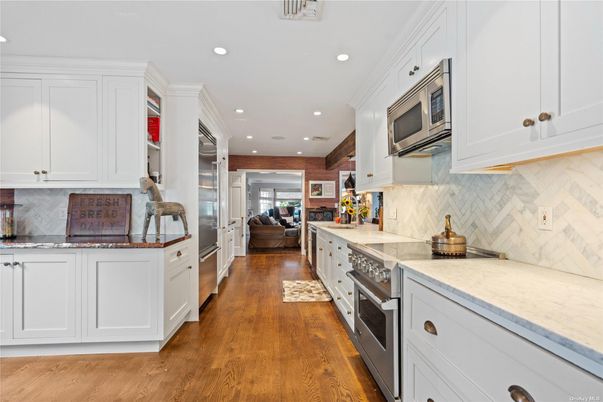 Interior, Kitchen, Marble Walls, Recessed Lighting, Stainless Steel Appliances, Wood Texture Flooring