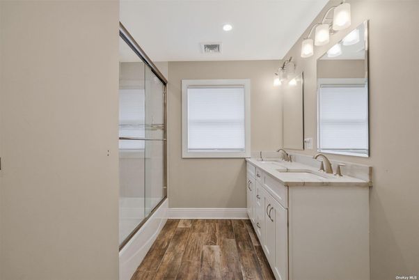 Bathroom, Dual Sink Vanities, Glass Shower, Interior, Recessed Lighting, Wood Texture Flooring