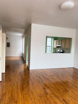Empty room, Interior, Kitchen, Pendant Lights, Stainless Steel Appliances, Wood Texture Flooring