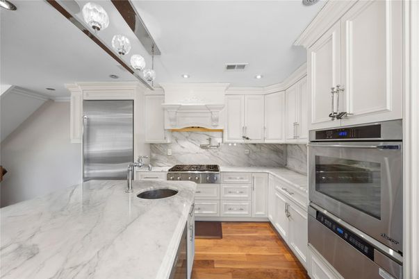 Interior, Kitchen, Marble Walls, Recessed Lighting, Stainless Steel Appliances, Wood Texture Flooring