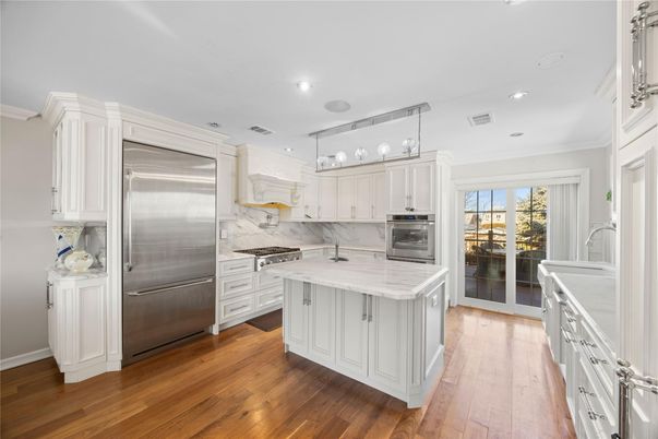 Interior, Kitchen, Marble Walls, Recessed Lighting, Stainless Steel Appliances, Wood Texture Flooring