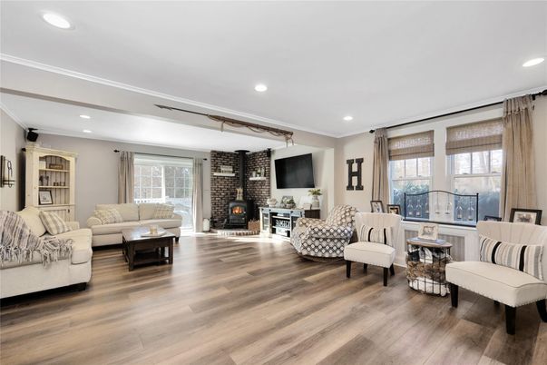 Fireplace, Interior, Living room, Recessed Lighting, Stone Walls, Wood Texture Flooring