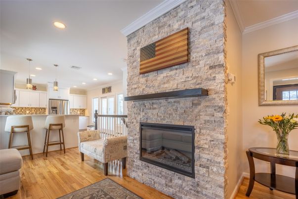 Fireplace, Interior, Kitchen, Pendant Lights, Recessed Lighting, Stainless Steel Appliances, Stone Walls, Wood Texture Flooring