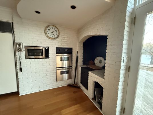 Fireplace, Interior, Kitchen, Recessed Lighting, Stainless Steel Appliances, Stone Walls, Wood Texture Flooring