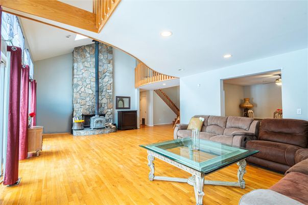 Fireplace, Interior, Living room, Recessed Lighting, Stone Walls, Wood Texture Flooring