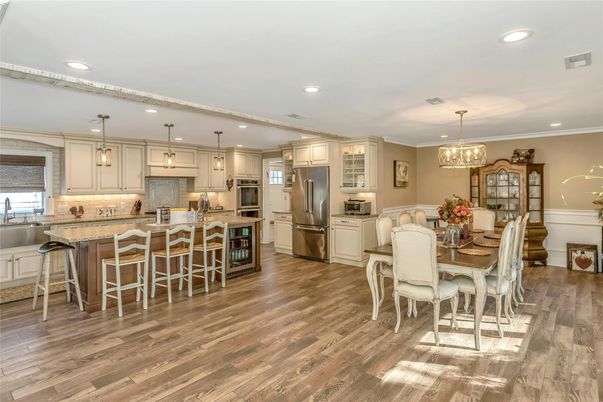Chandelier, Dining room, Interior, Kitchen, Pendant Lights, Recessed Lighting, Stainless Steel Appliances, Wood Texture Flooring