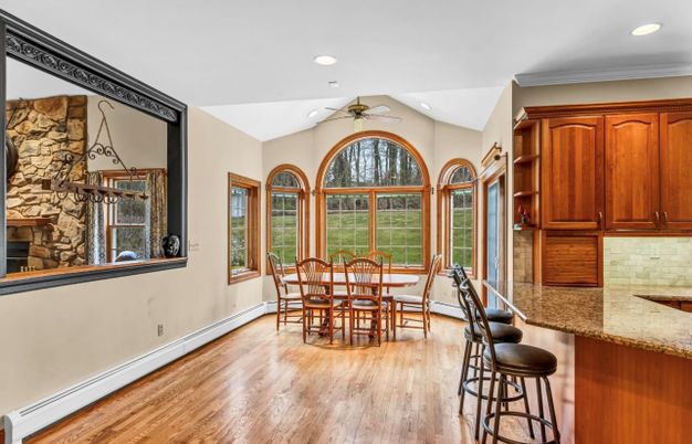 Dining room, Fireplace, Interior, Recessed Lighting, Stone Walls, Wood Texture Flooring