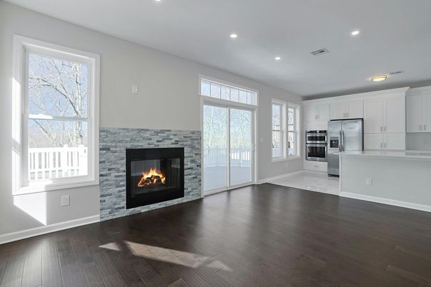 Empty room, Fireplace, Interior, Kitchen, Recessed Lighting, Stainless Steel Appliances, Wood Texture Flooring
