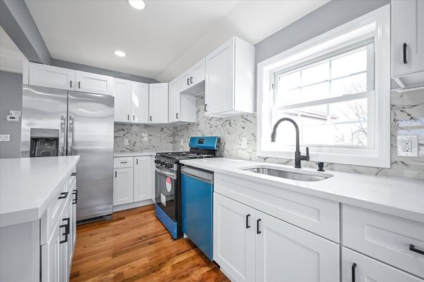 Interior, Kitchen, Marble Walls, Recessed Lighting, Stainless Steel Appliances, Wood Texture Flooring