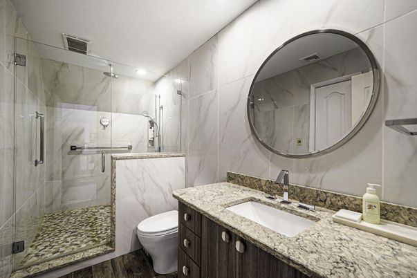 Bathroom, Glass Shower, Interior, Marble Walls, Recessed Lighting, Wood Texture Flooring