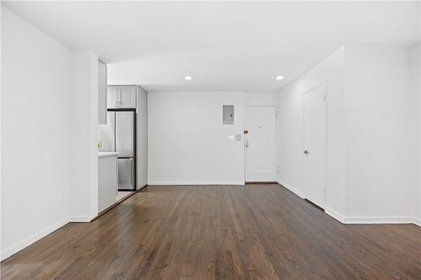 Empty room, Interior, Kitchen, Recessed Lighting, Stainless Steel Appliances, Wood Texture Flooring