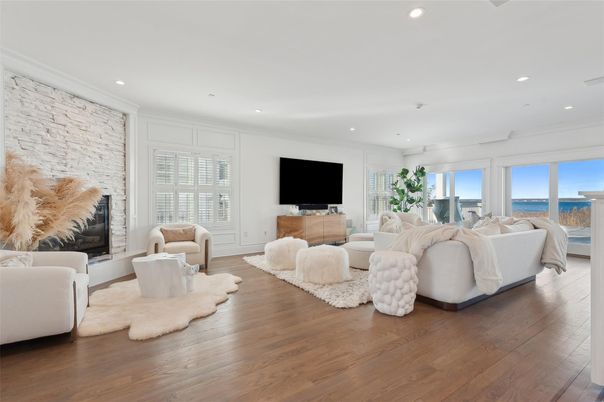 Fireplace, Interior, Living room, Recessed Lighting, Stone Walls, Water, Wood Texture Flooring