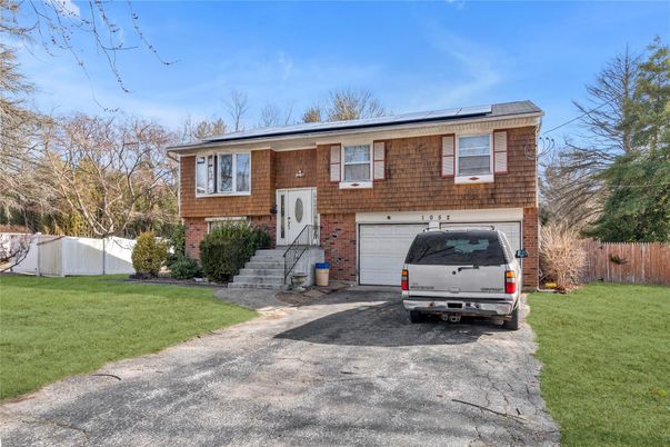 Attached, Exterior, Facade, Brick Facade, Solar Panels, Raised Ranch
