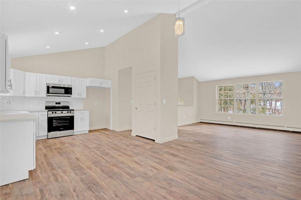 Empty room, Interior, Kitchen, Pendant Lights, Recessed Lighting, Stainless Steel Appliances, Wood Texture Flooring