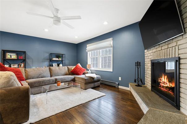 Fireplace, Interior, Living room, Recessed Lighting, Stone Walls, Wood Texture Flooring