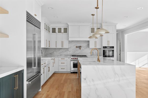 Interior, Kitchen, Marble Walls, Pendant Lights, Recessed Lighting, Stainless Steel Appliances, Wood Texture Flooring