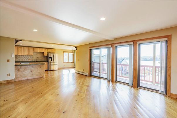 Empty room, Interior, Kitchen, Recessed Lighting, Stainless Steel Appliances, Wood Texture Flooring