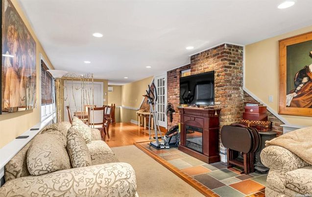 Dining room, Fireplace, Interior, Living room, Recessed Lighting, Stone Walls, Wood Texture Flooring