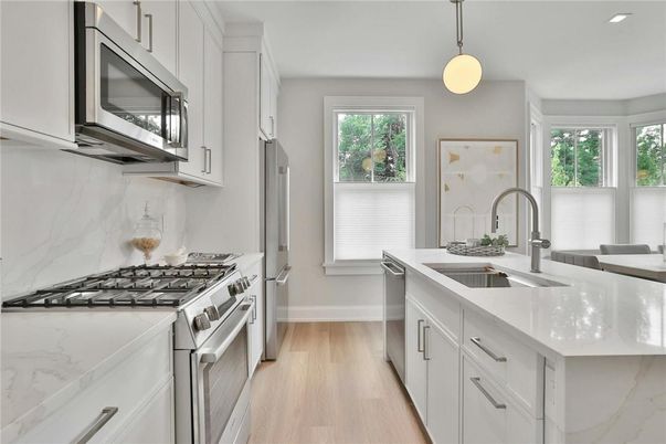 Interior, Kitchen, Marble Walls, Pendant Lights, Recessed Lighting, Stainless Steel Appliances, Wood Texture Flooring