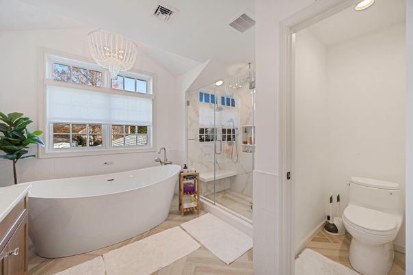 Bathroom, Chandelier, Free Standing Baths, Glass Shower, Interior, Marble Walls, Recessed Lighting, Wood Texture Flooring