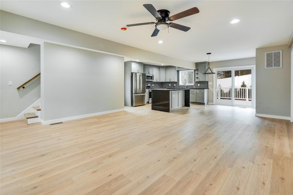 Empty room, Interior, Kitchen, Pendant Lights, Recessed Lighting, Stainless Steel Appliances, Wood Texture Flooring