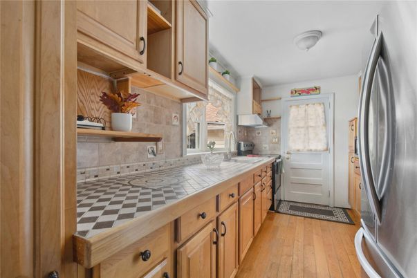 Interior, Kitchen, Stainless Steel Appliances, Tile Countertops, Wood Texture Flooring