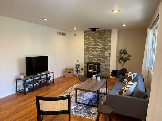 Fireplace, Interior, Living room, Recessed Lighting, Stone Walls, Wood Texture Flooring