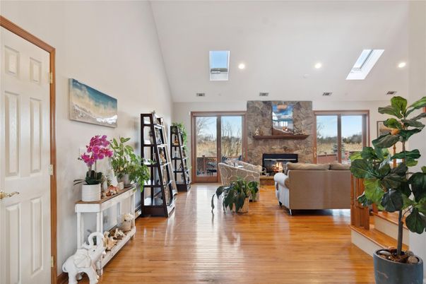 Fireplace, Interior, Living room, Recessed Lighting, Stone Walls, Wood Texture Flooring