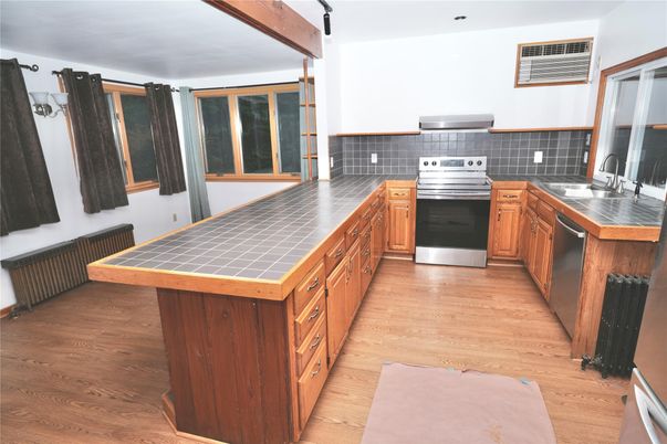 Interior, Kitchen, Stainless Steel Appliances, Tile Countertops, Wood Texture Flooring