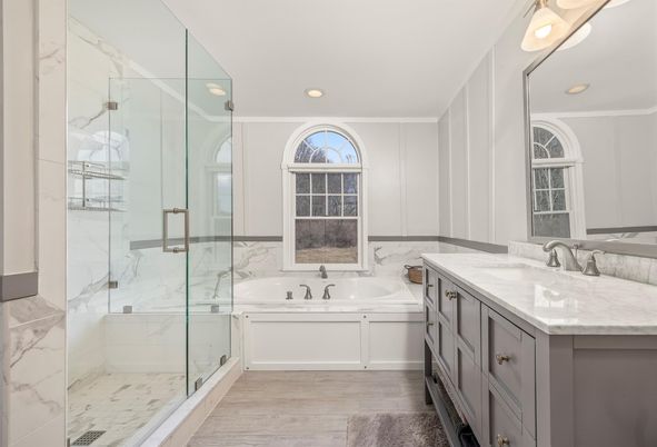 Bathroom, Dual Sink Vanities, Glass Shower, Interior, Marble Walls, Recessed Lighting, Wood Texture Flooring