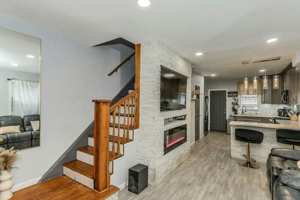 Fireplace, Interior, Kitchen, Pendant Lights, Recessed Lighting, Stainless Steel Appliances, Stone Walls, Wood Texture Flooring
