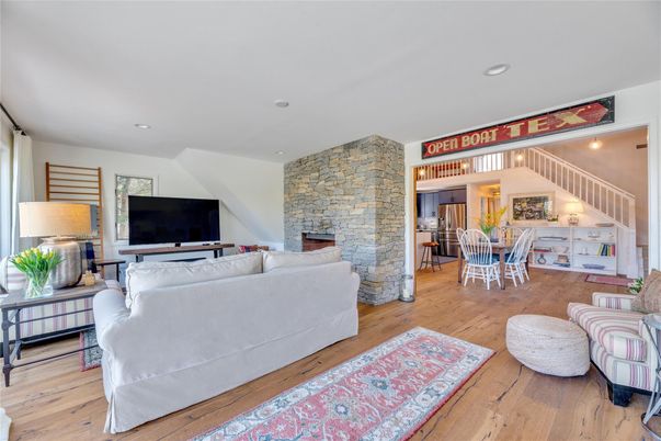 Dining room, Fireplace, Interior, Living room, Recessed Lighting, Stone Walls, Wood Texture Flooring