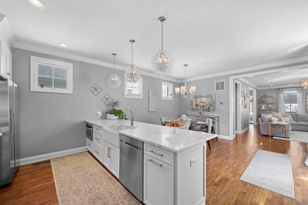 Chandelier, Dining room, Interior, Kitchen, Living room, Pendant Lights, Recessed Lighting, Stainless Steel Appliances, Wood Texture Flooring