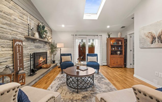 Fireplace, Interior, Living room, Recessed Lighting, Stone Walls, Wood Texture Flooring