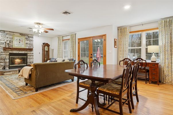Dining room, Fireplace, Interior, Living room, Recessed Lighting, Stone Walls, Wood Texture Flooring