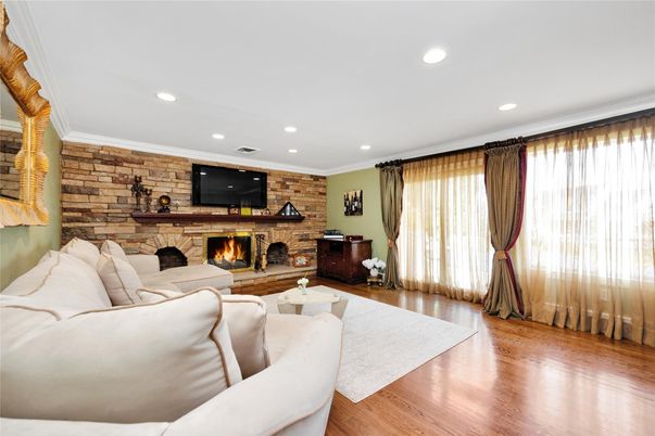 Fireplace, Interior, Living room, Recessed Lighting, Stone Walls, Wood Texture Flooring