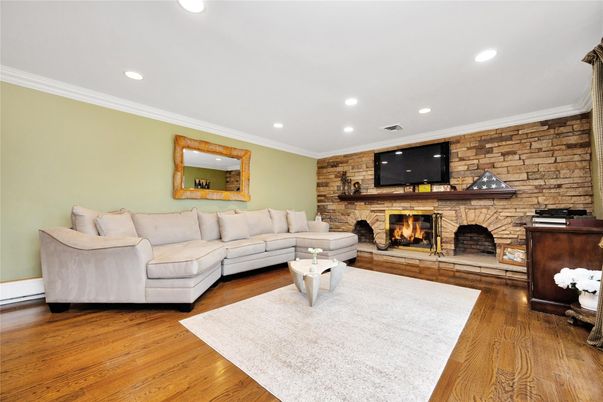 Fireplace, Interior, Living room, Recessed Lighting, Stone Walls, Wood Texture Flooring