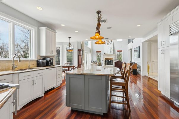 Chandelier, Dining room, Fireplace, Interior, Kitchen, Pendant Lights, Recessed Lighting, Stainless Steel Appliances, Wood Texture Flooring