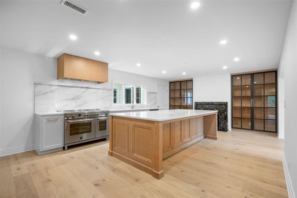 Interior, Kitchen, Marble Walls, Recessed Lighting, Stainless Steel Appliances, Wood Texture Flooring