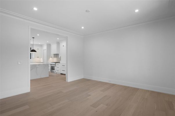 Empty room, Interior, Kitchen, Marble Walls, Pendant Lights, Recessed Lighting, Stainless Steel Appliances, Wood Texture Flooring