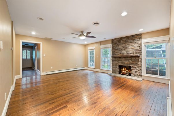 Empty room, Fireplace, Interior, Recessed Lighting, Stone Walls, Wood Texture Flooring